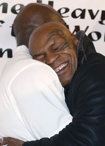 Tyson hugs Holyfield