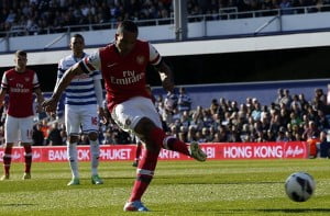 Arsenal's Theo Walcott shoots and scores his goal against Queens Park Rangers during their English Premier League soccer match at Loftus Road in London
