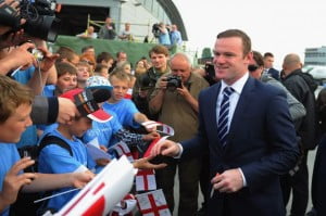 Rooney signs autographs